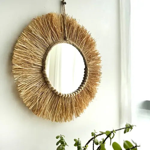 Miroir mural en raphia avec perles en bois pour une décoration rustique.