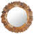 Miroir rond bois flotté intégré dans une décoration de salon naturel avec canapé beige, coussins ethniques et tapis en fibres naturelles.